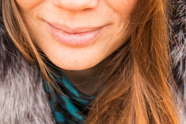 Smiling Woman Wearing Gray Fur Top